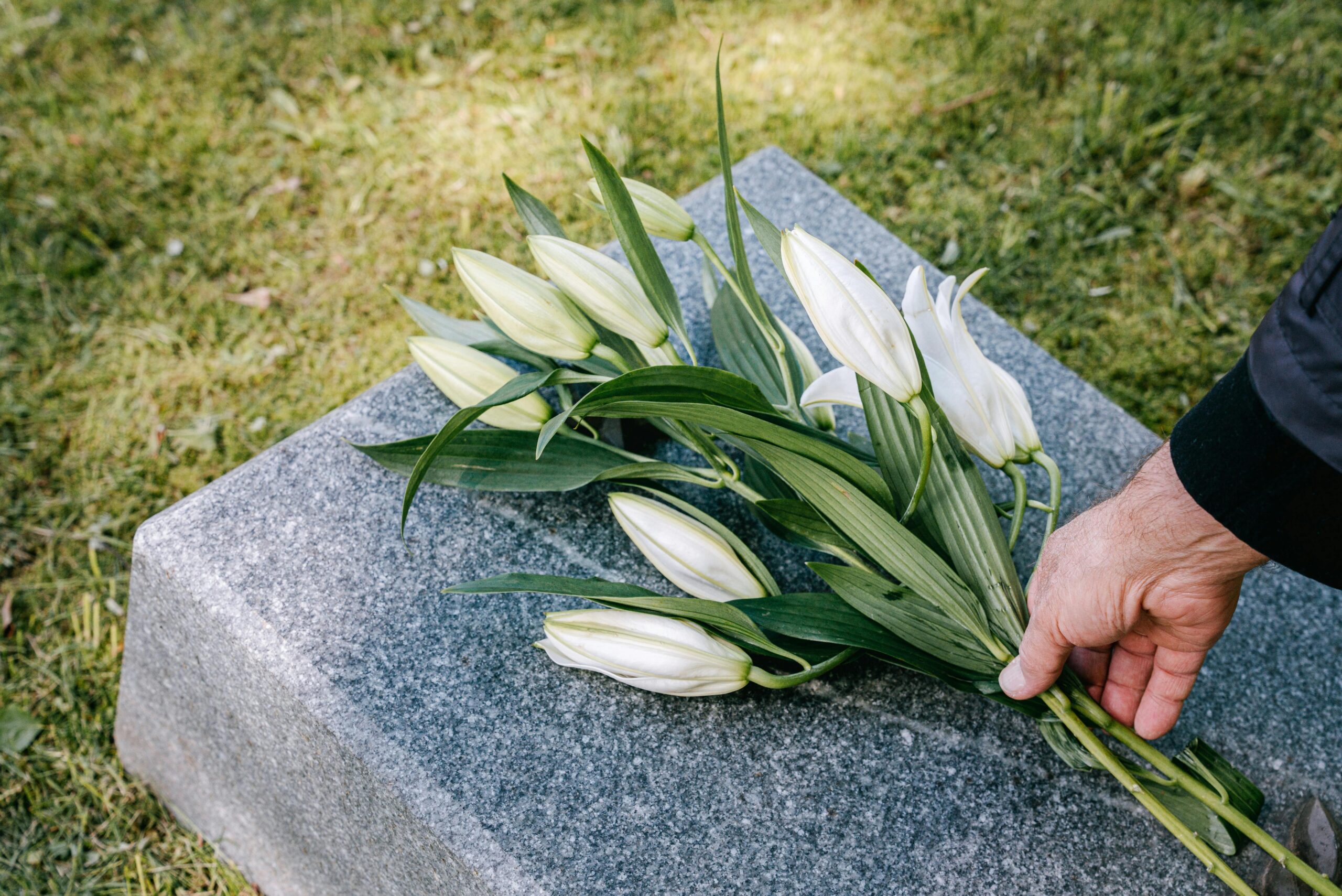 Care plans for gravesite upkeep in Saratoga County, NY with fresh flowers placed neatly on a gravestone for a respectful memorial presentation.