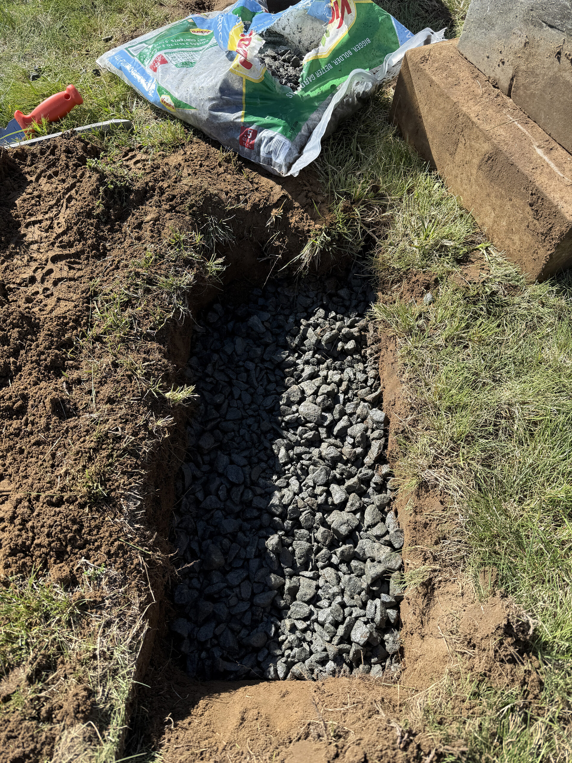 Crushed stone base preparation for gravestone leveling and reset