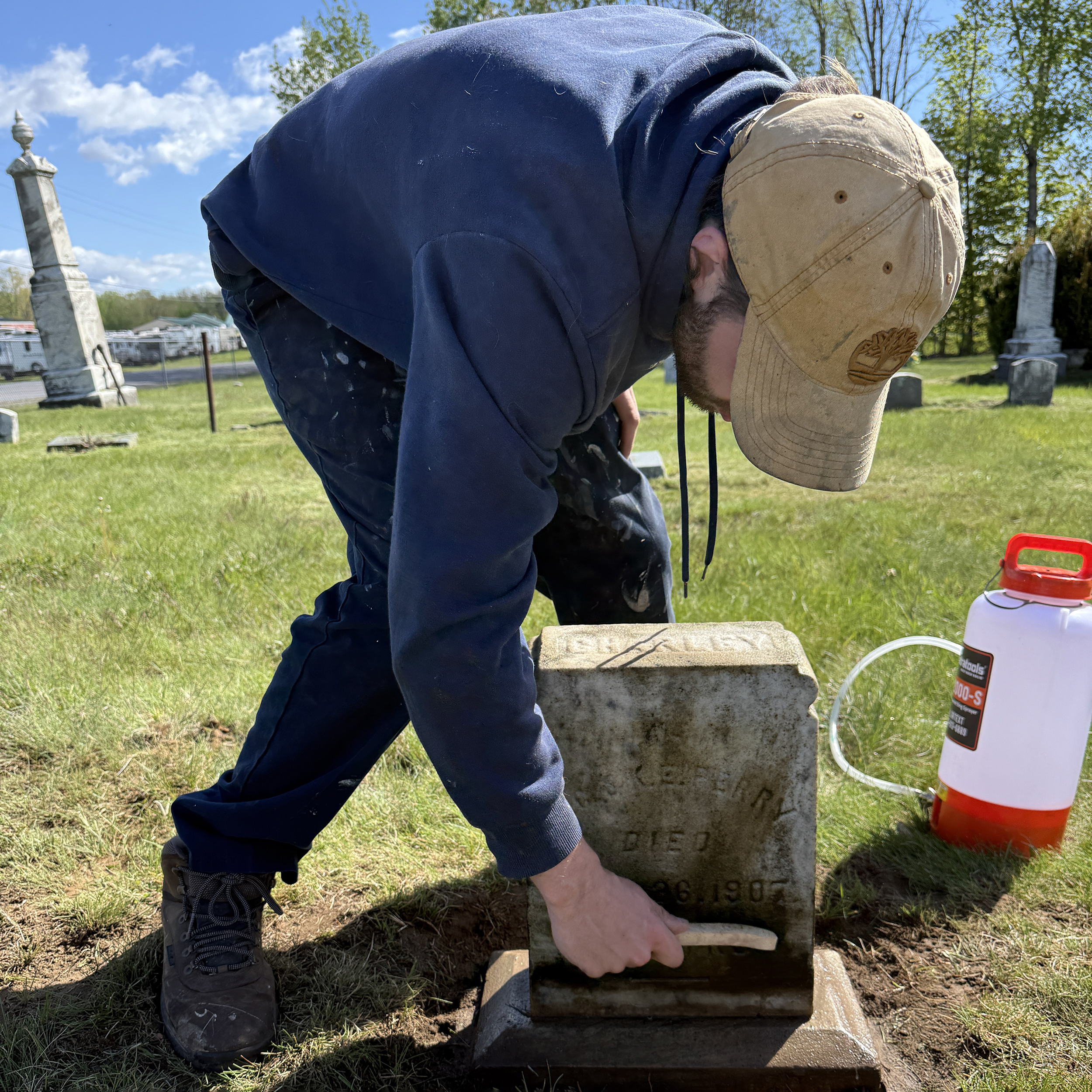 Cleaning a gravestone by hand in Gurn Spring Cemetery, Saratoga County, New York.
