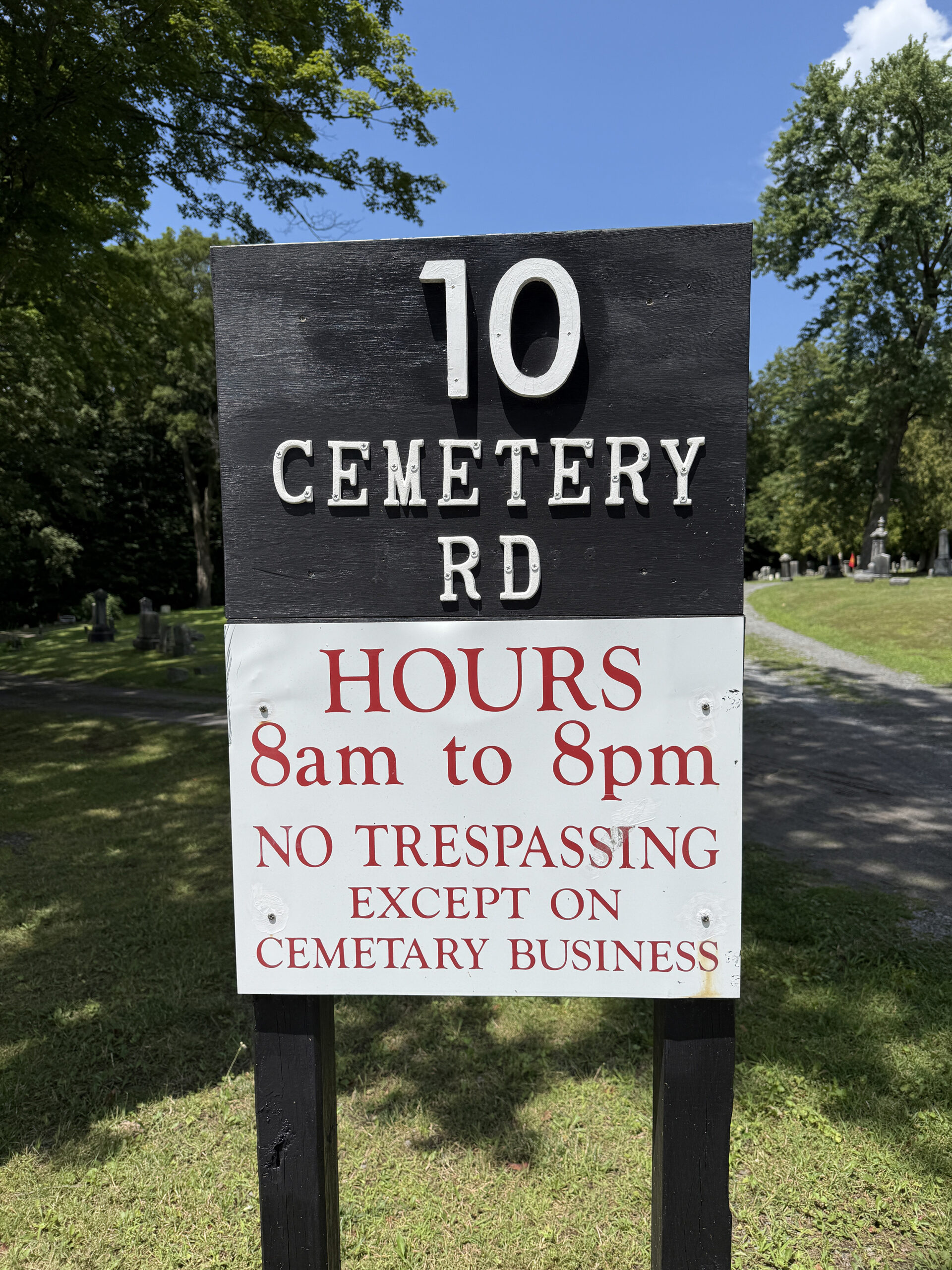 Clifton Park Village Cemetery hours sign showing Cemetery Road and posted visiting hours from 8am to 8pm