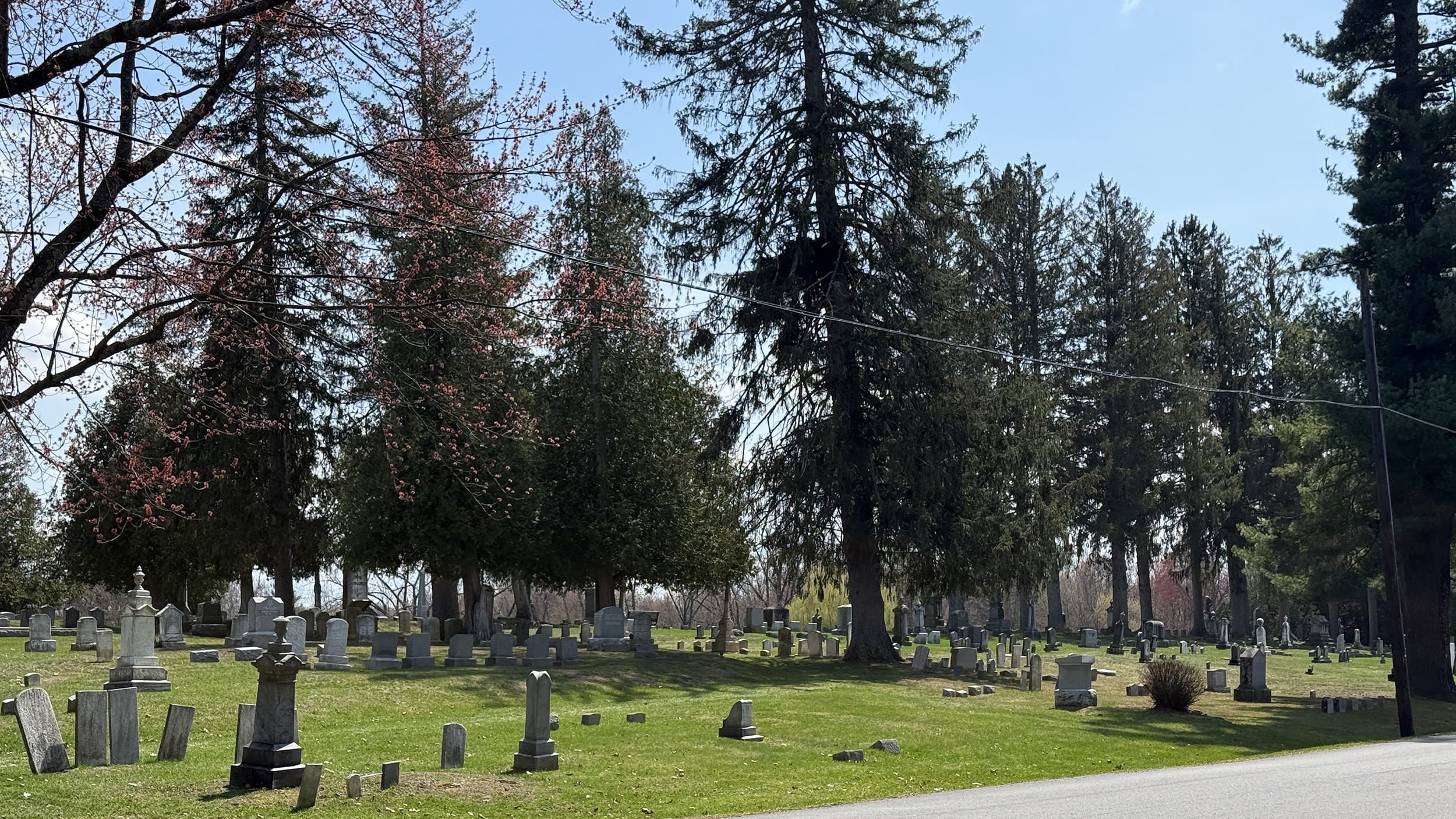 Roadside view of Prospect Hill Cemetery in Schuylerville New York with historic headstones and mature trees