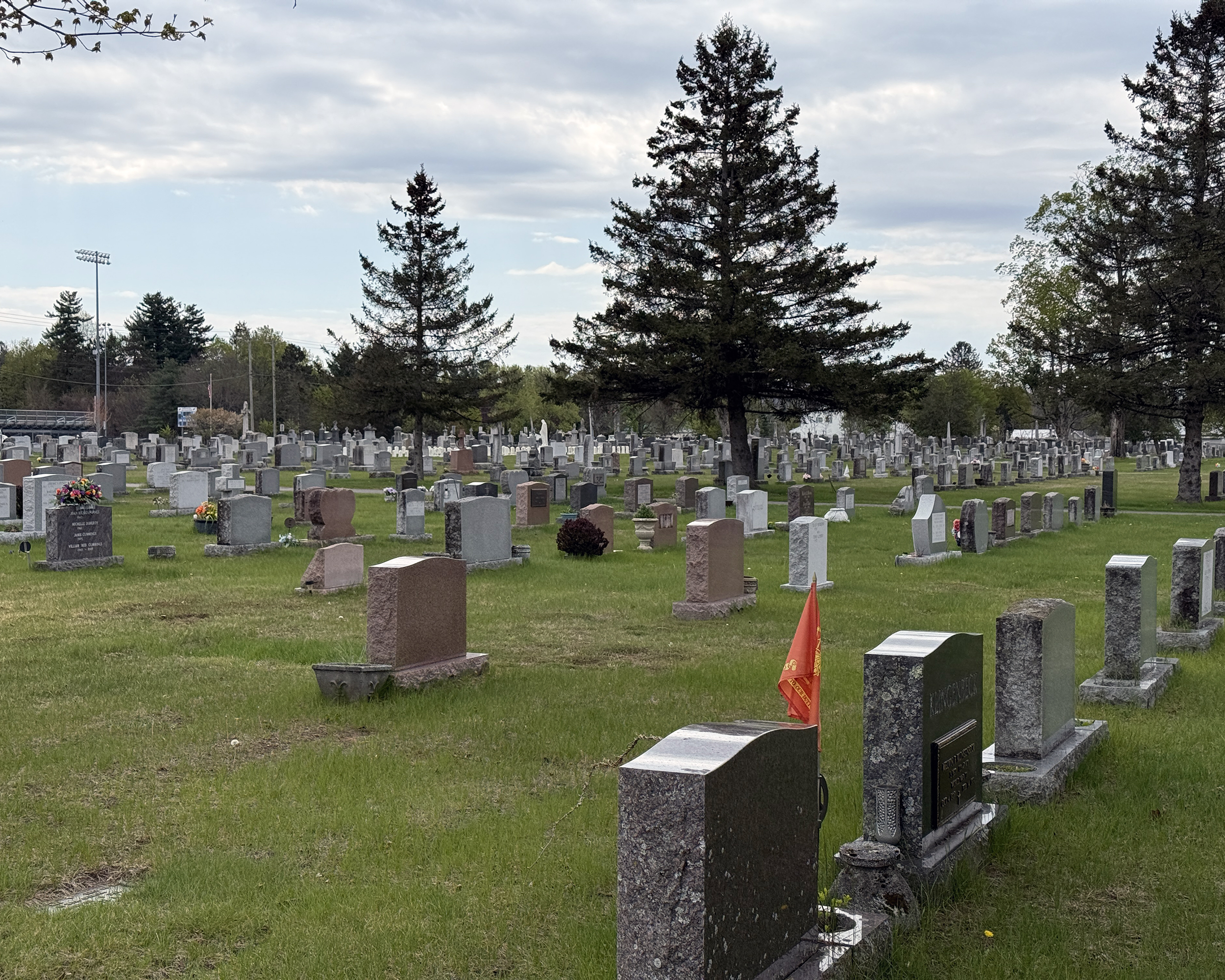 Gravestones and burial plots at St. Peter’s Cemetery in Saratoga Springs NY with varied monument styles and layouts.