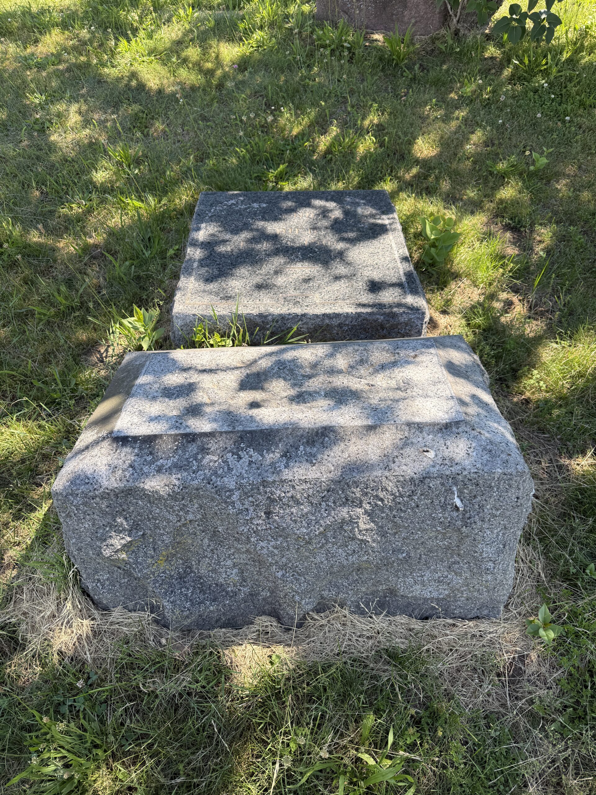 Broken and fallen headstone documented before cemetery repair and stabilization planning