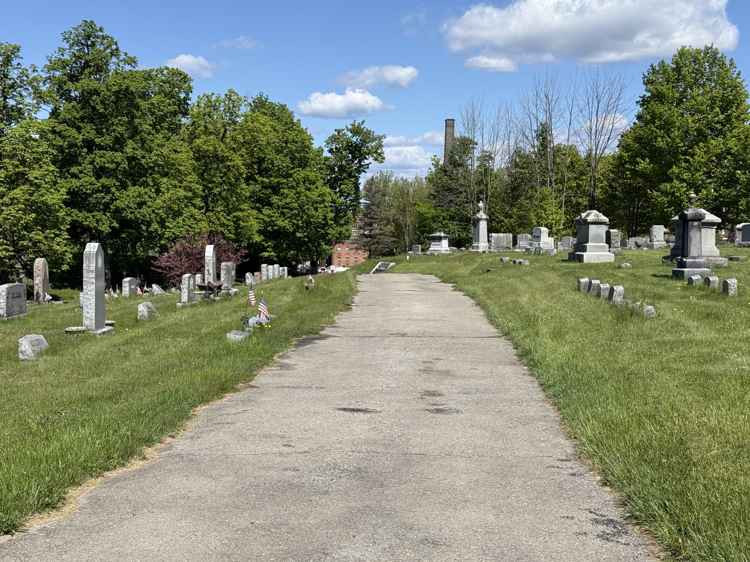 Roadway through Green Hill Cemetery in Amsterdam New York with historic monuments and mature trees