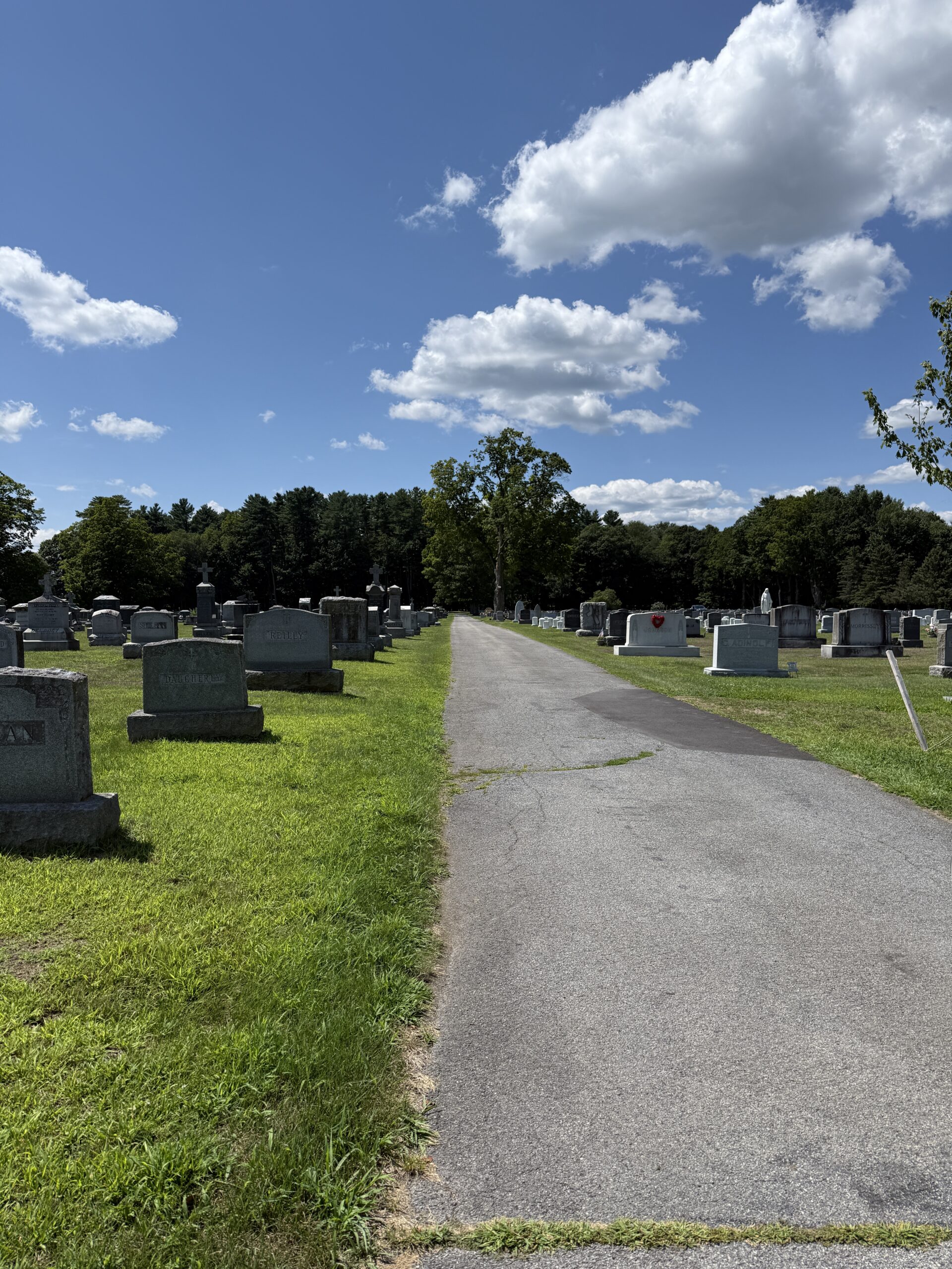 Main roadway through St. Peter's Cemetery in Saratoga Springs New York showing active burial sections and family memorials