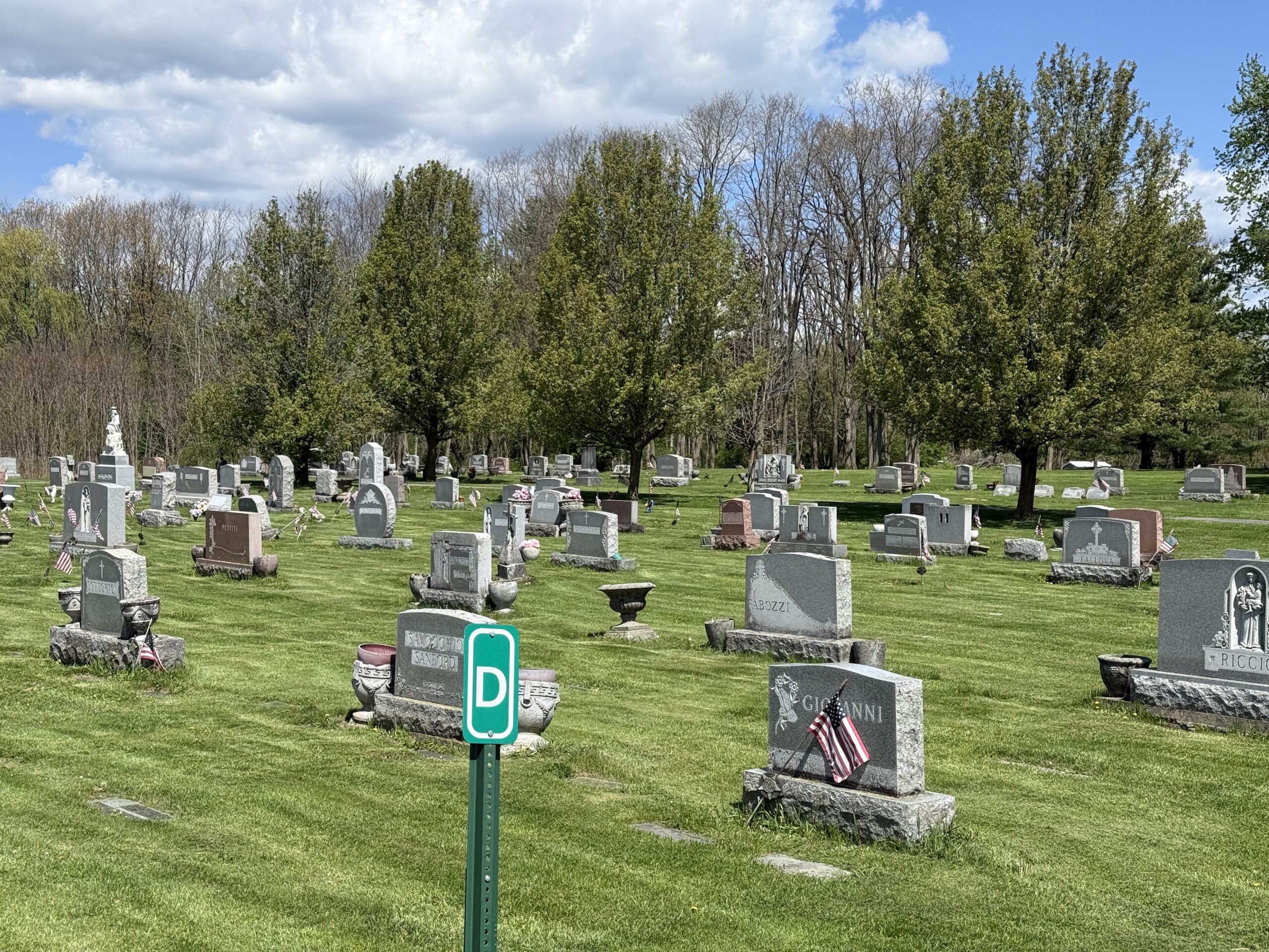 Gravestones and family memorials in the Mount Carmel Cemetery landscape in Amsterdam New York
